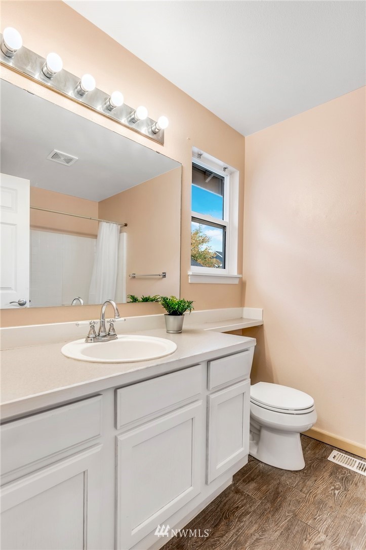 13402 Prospector Ridge Road Southeast Monroe, WA 98272 - Photo 21 of 30 a bathroom with a toilet a sink and mirror
