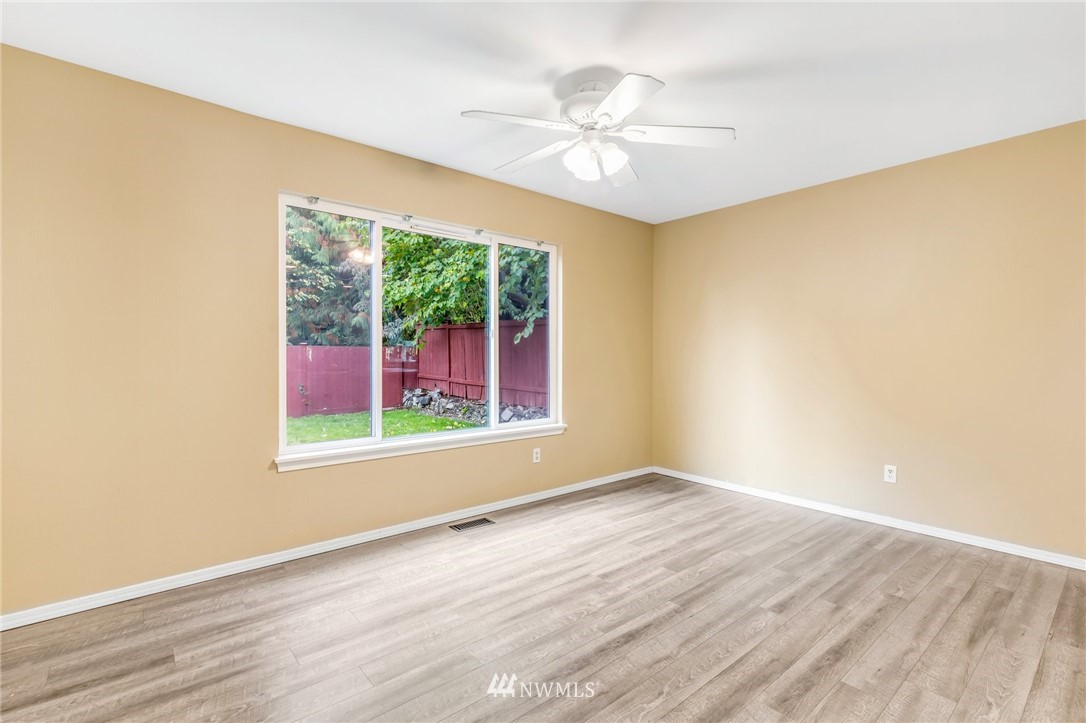 13402 Prospector Ridge Road Southeast Monroe, WA 98272 - Photo 9 of 30 a view of an empty room with wooden floor and a window
