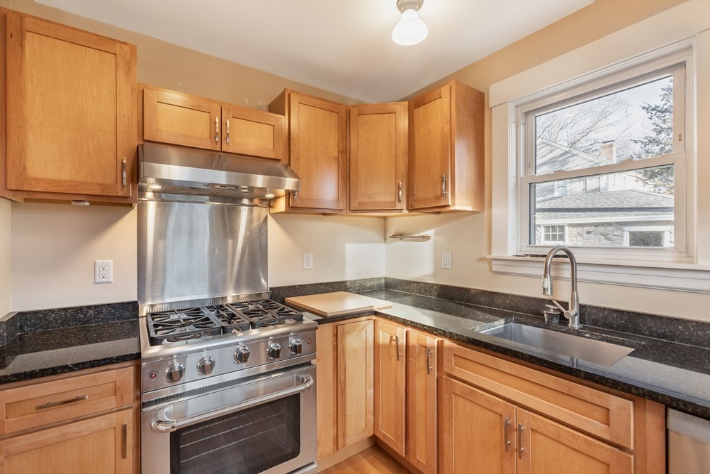 102 Great Road Maynard, MA 01754 - Photo 5 of 32 a kitchen with granite countertop a sink stainless steel appliances and cabinets