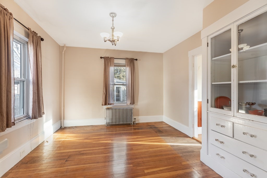 102 Great Road Maynard, MA 01754 - Photo 10 of 32 a view of an empty room with cabinet and window