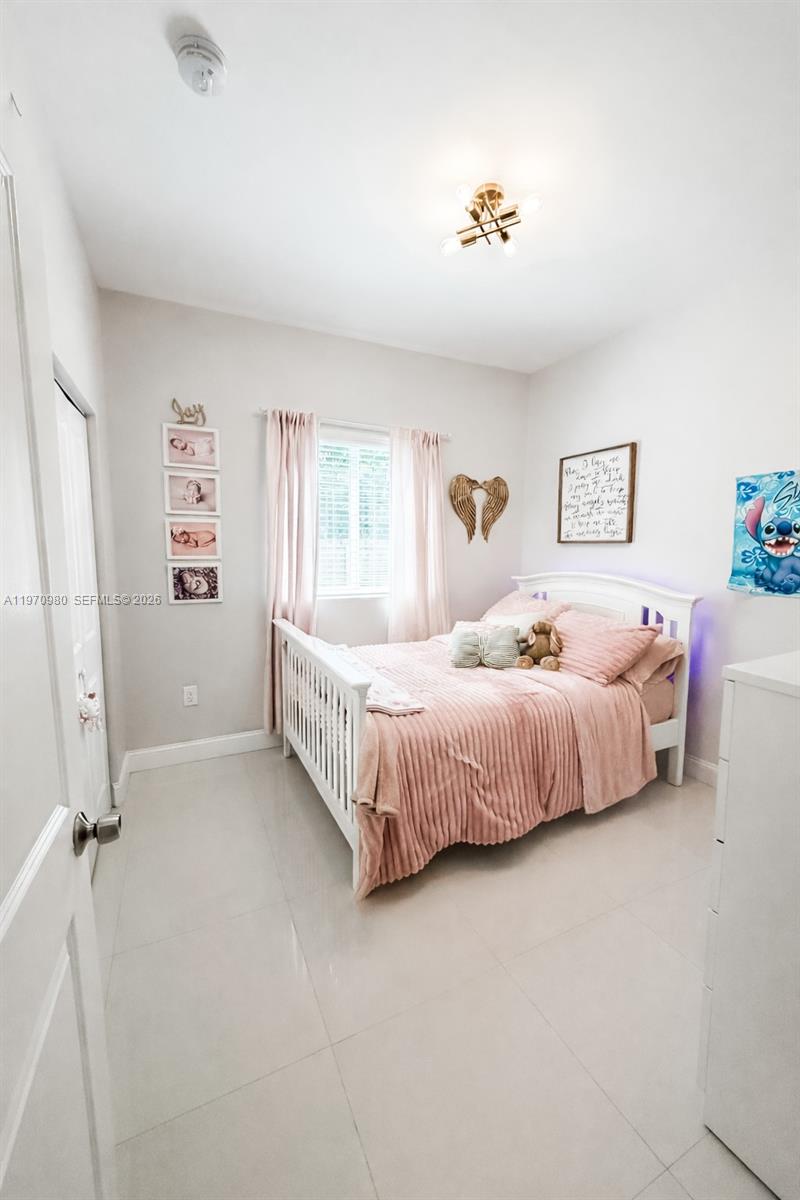 30725 Southwest 158 Path Homestead, FL 33033 - Photo 11 of 29 a bedroom with a bed and a walk in closet