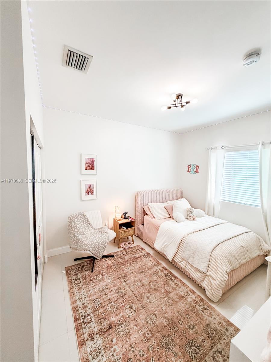 30725 Southwest 158 Path Homestead, FL 33033 - Photo 12 of 29 a bedroom with a bed and a window