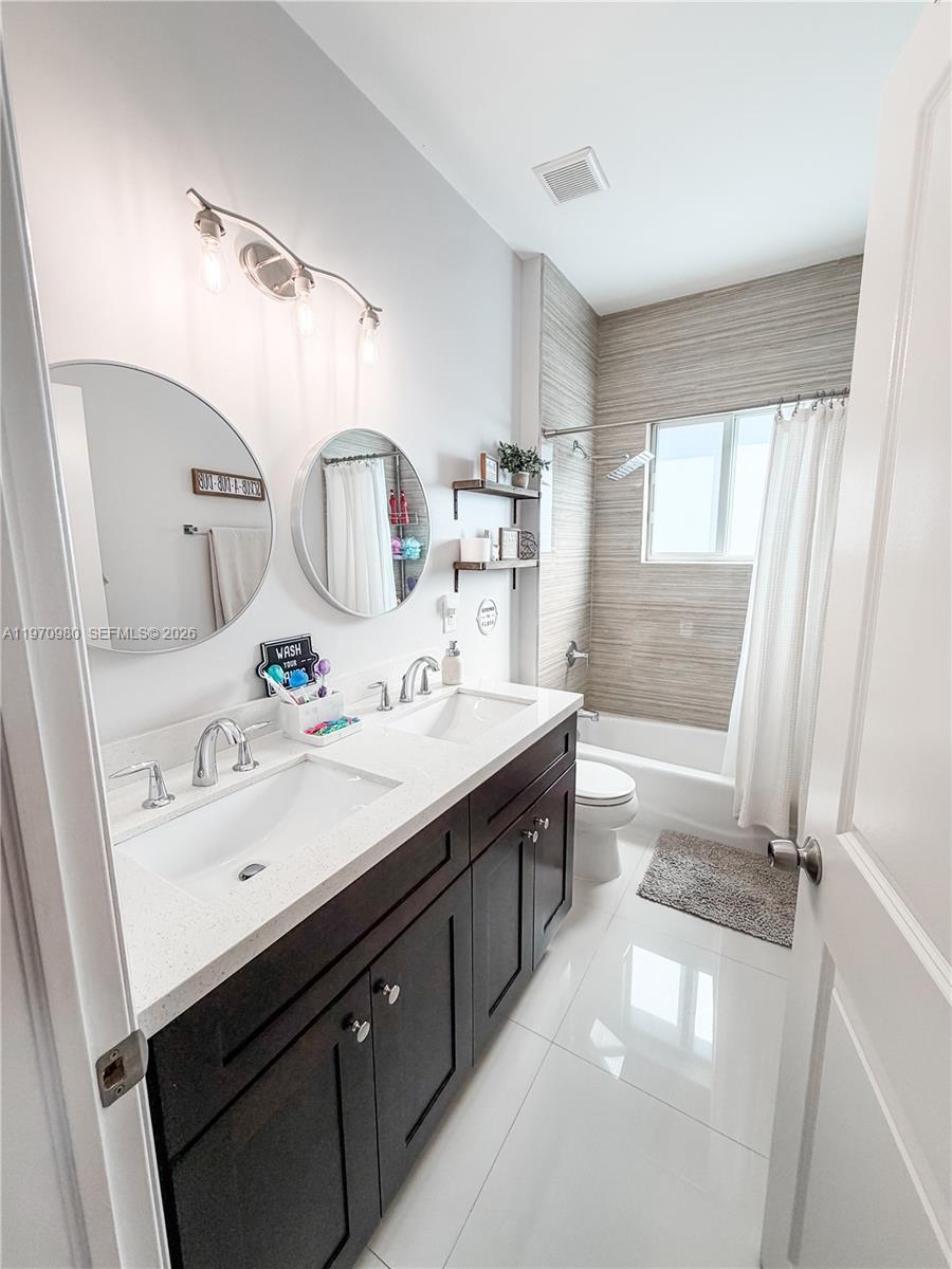 30725 Southwest 158 Path Homestead, FL 33033 - Photo 13 of 29 a spacious bathroom with a sink double vanity and a mirror