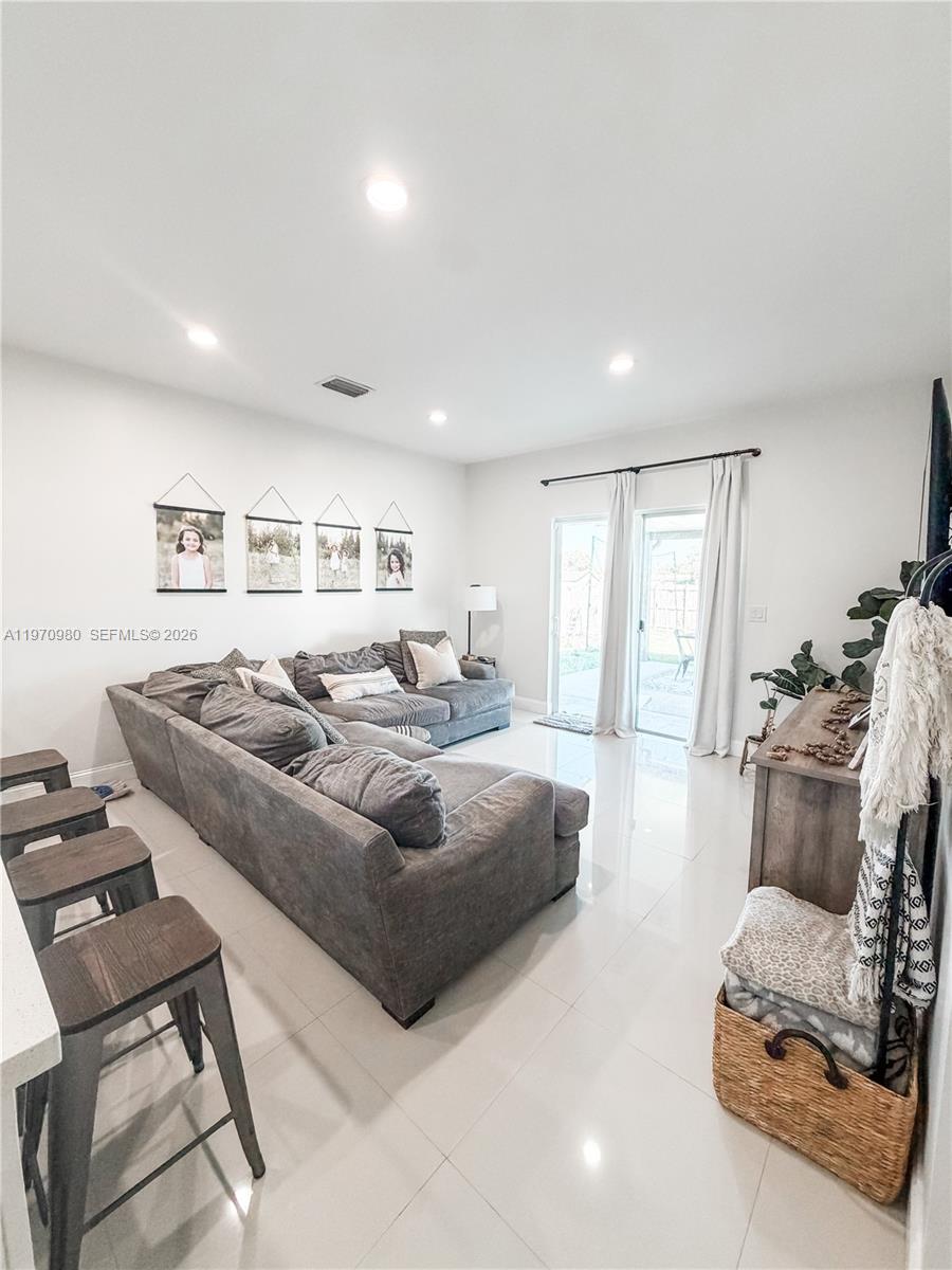 30725 Southwest 158 Path Homestead, FL 33033 - Photo 6 of 29 a living room with furniture and a flat screen tv