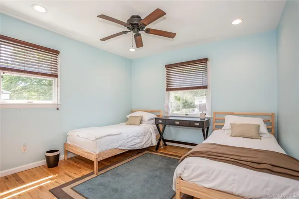 a bedroom with furniture and wooden floor