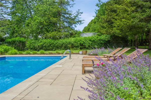 a view of a swimming pool with an outdoor space and seating area