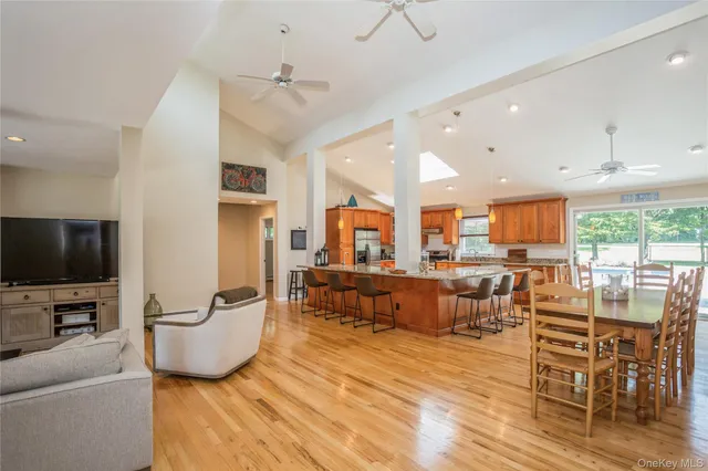 a living room with furniture wooden floor and a flat screen tv