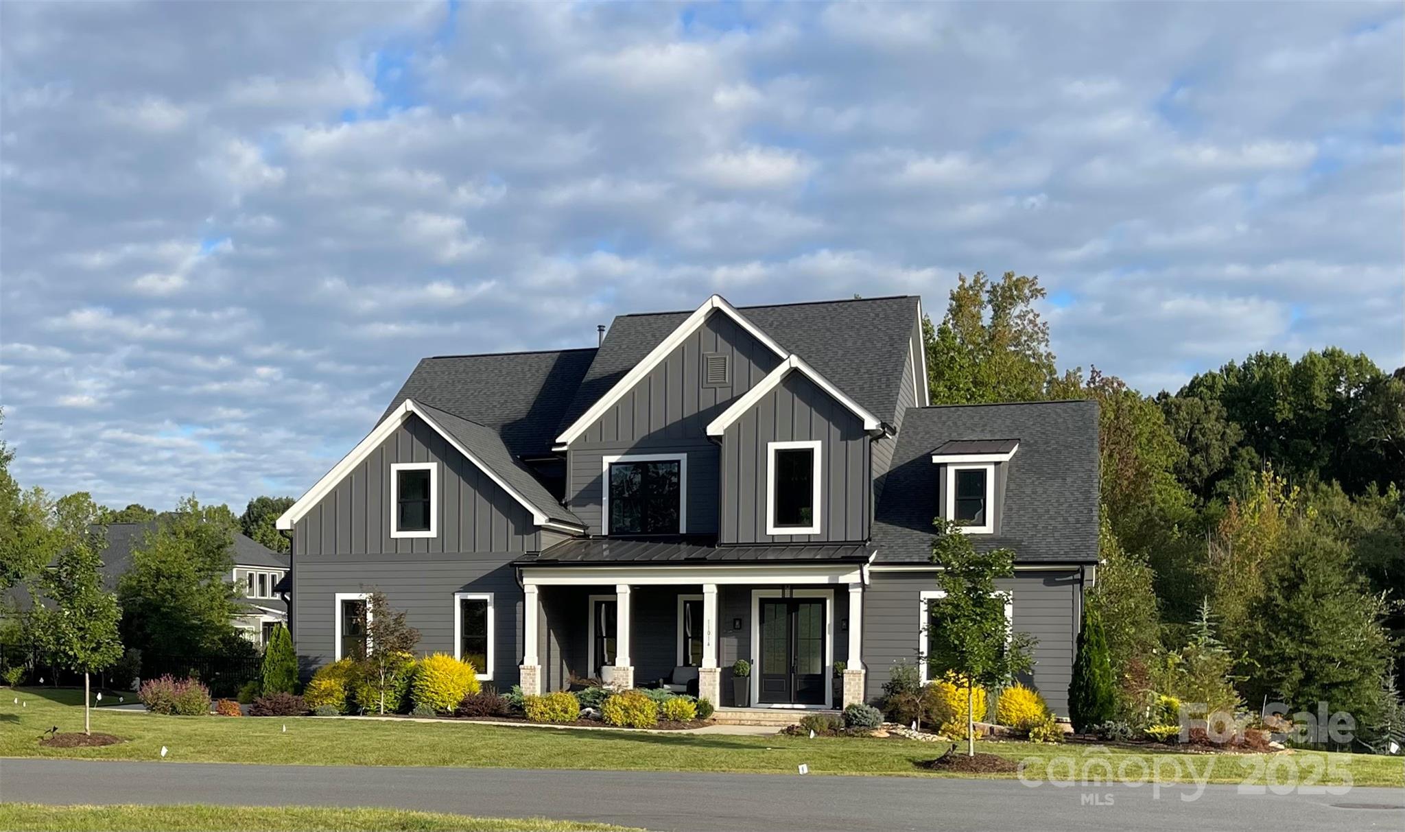 11014 Mountain Willow Trail Huntersville, NC 28078 - Photo 2 of 4 a front view of a house with a garden and trees