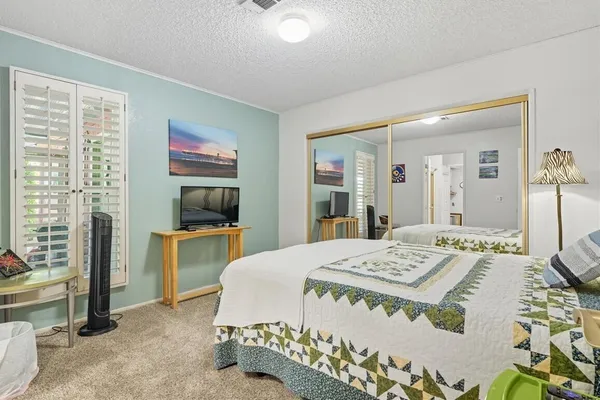 a living room with a bed furniture and next to a window