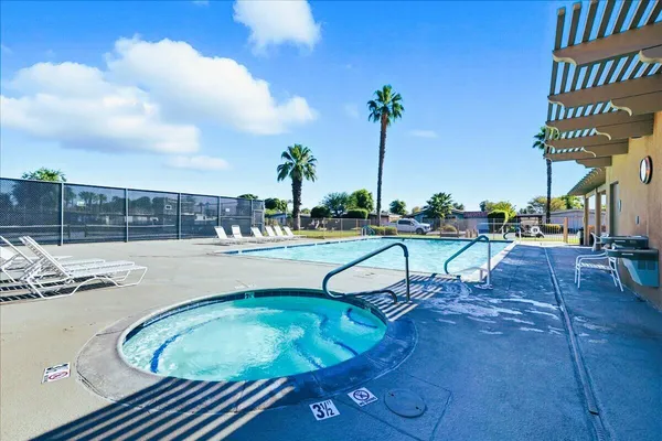 a view of a swimming pool with a lounge chair