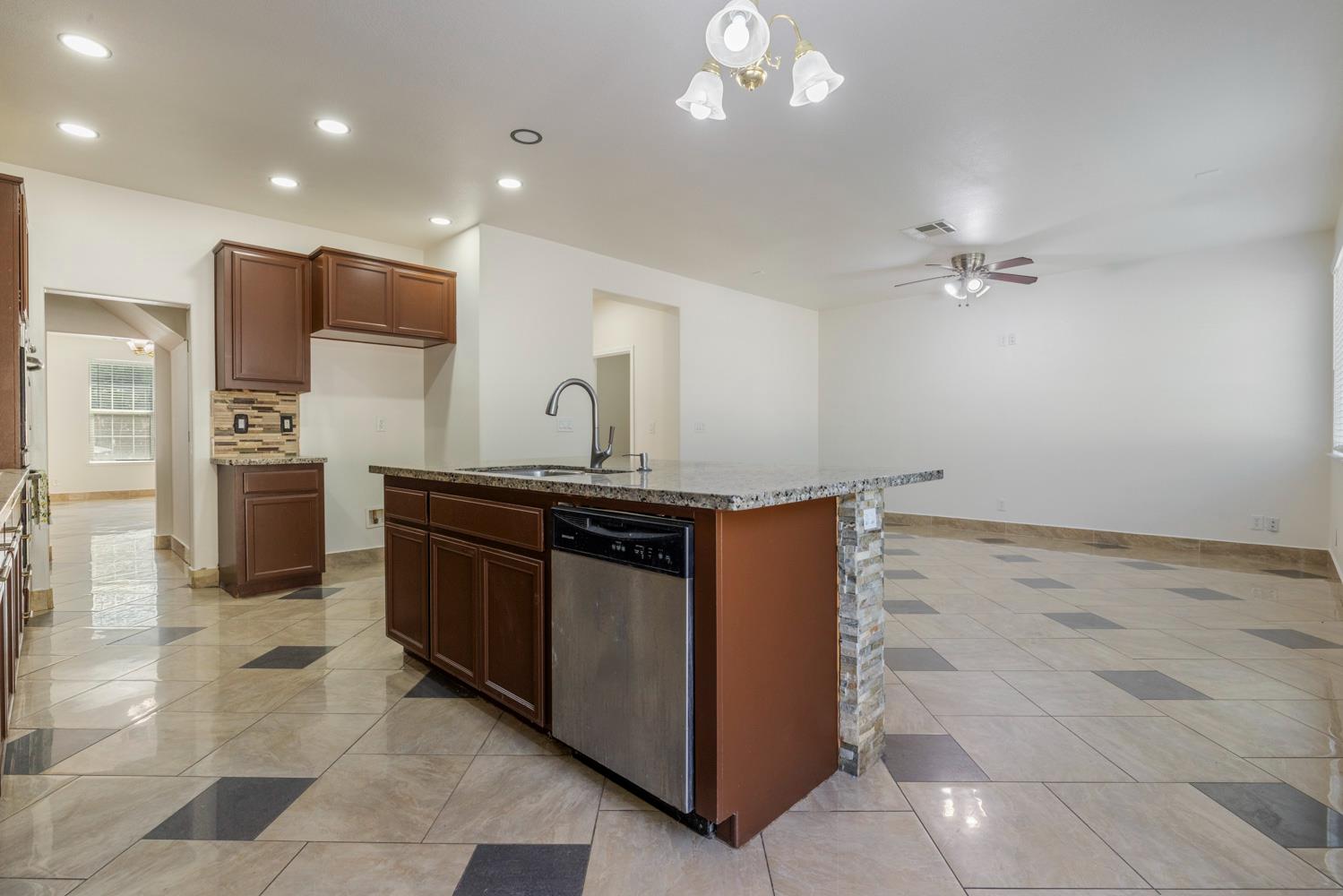 3105 Ripple Court Modesto, CA 95355 - Photo 14 of 46 a kitchen with stainless steel appliances granite countertop a sink and a refrigerator