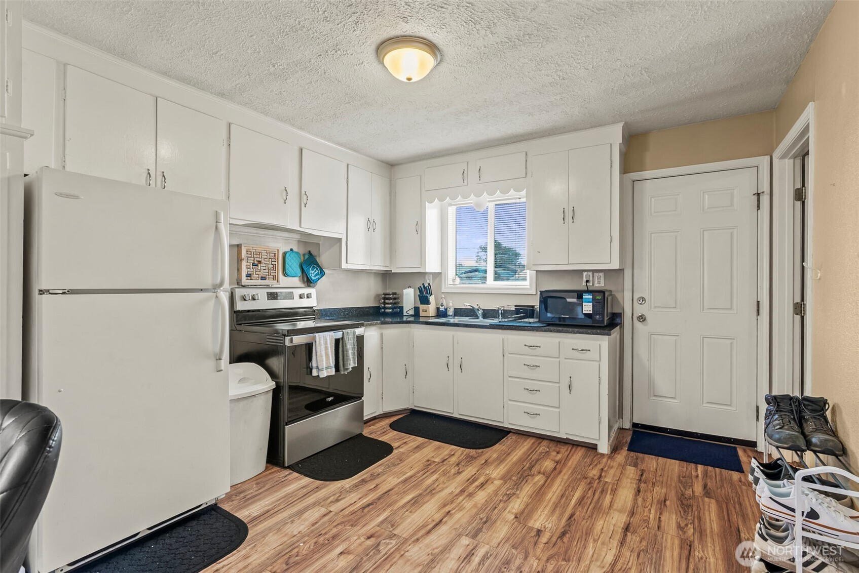 349 27th Avenue Longview, WA 98632 - Photo 13 of 23 a kitchen with a refrigerator stove and white cabinets