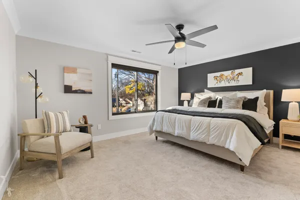 a bedroom with a bed and a painting on the wall