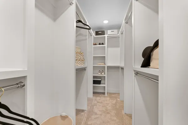 a view of walk in closet with empty racks