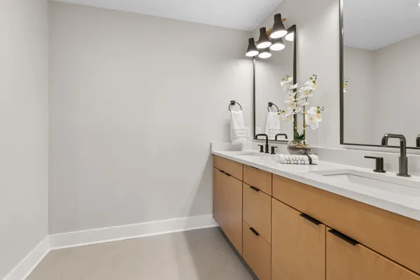 a bathroom with a double vanity sink and a mirror