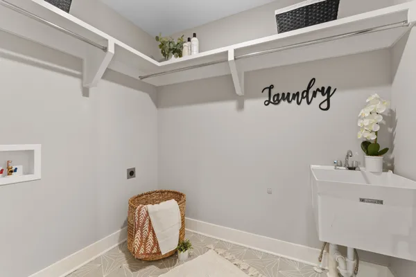 an empty room with ceiling fan and windows