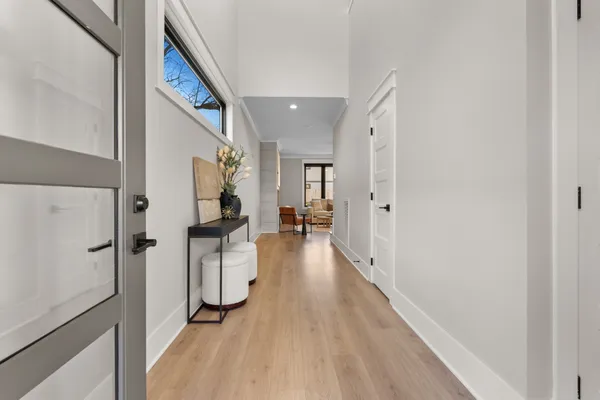 a hallway with wooden floor electronic appliances and furniture