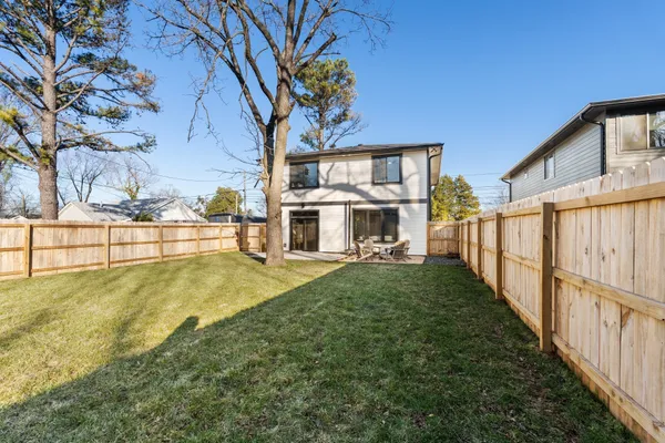 a view of a house with backyard porch and sitting area