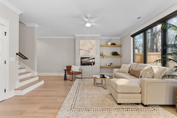 a living room with furniture and large windows