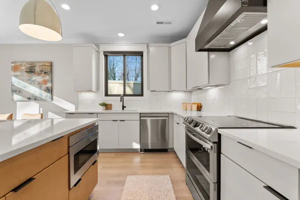 a kitchen with a sink stove and cabinets