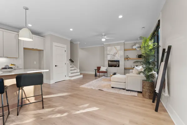 a living room with furniture a fireplace and a chandelier