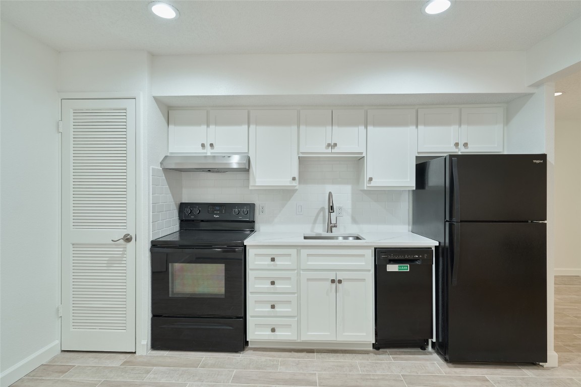 12900 Walden Road, Unit 601F Montgomery, TX 77356 - Photo 11 of 28 a kitchen with cabinets stainless steel appliances and a counter space