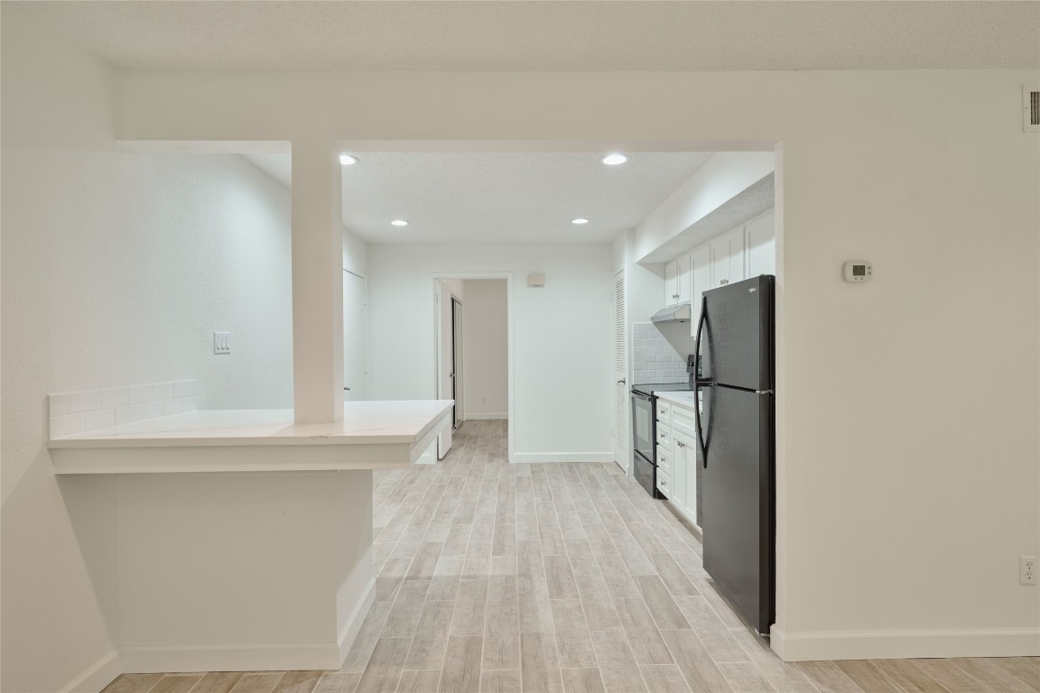 12900 Walden Road, Unit 601F Montgomery, TX 77356 - Photo 12 of 28 a view of a kitchen with a refrigerator and a sink