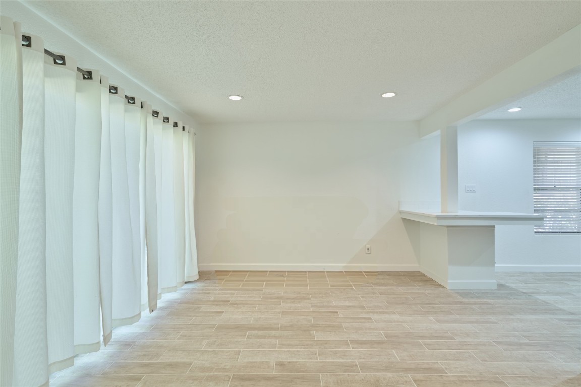 12900 Walden Road, Unit 601F Montgomery, TX 77356 - Photo 28 of 28 a view of a kitchen with white cabinets and wooden floor