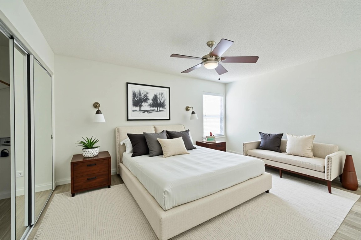 12900 Walden Road, Unit 601F Montgomery, TX 77356 - Photo 15 of 28 a bedroom with a bed and ceiling fan