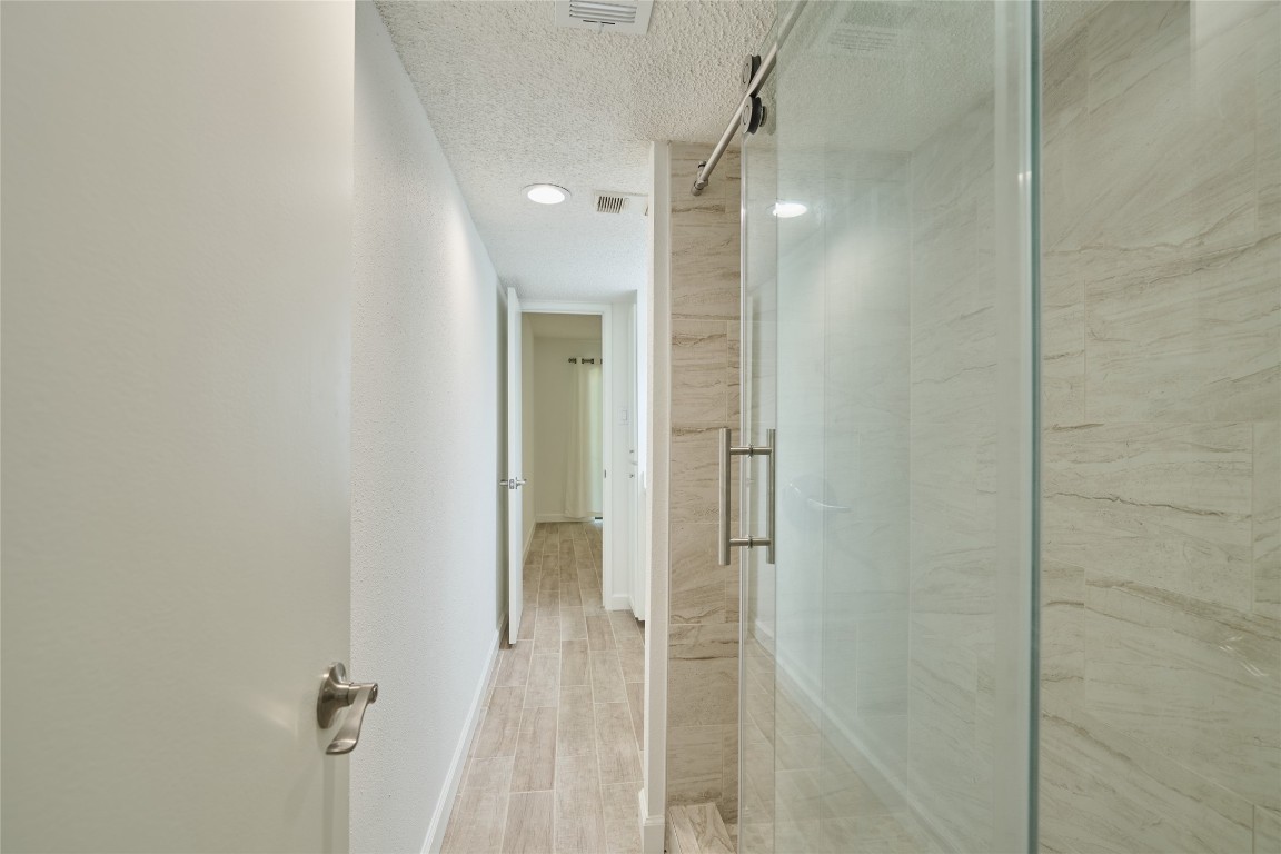 12900 Walden Road, Unit 601F Montgomery, TX 77356 - Photo 20 of 28 a bathroom with a shower and a glass door