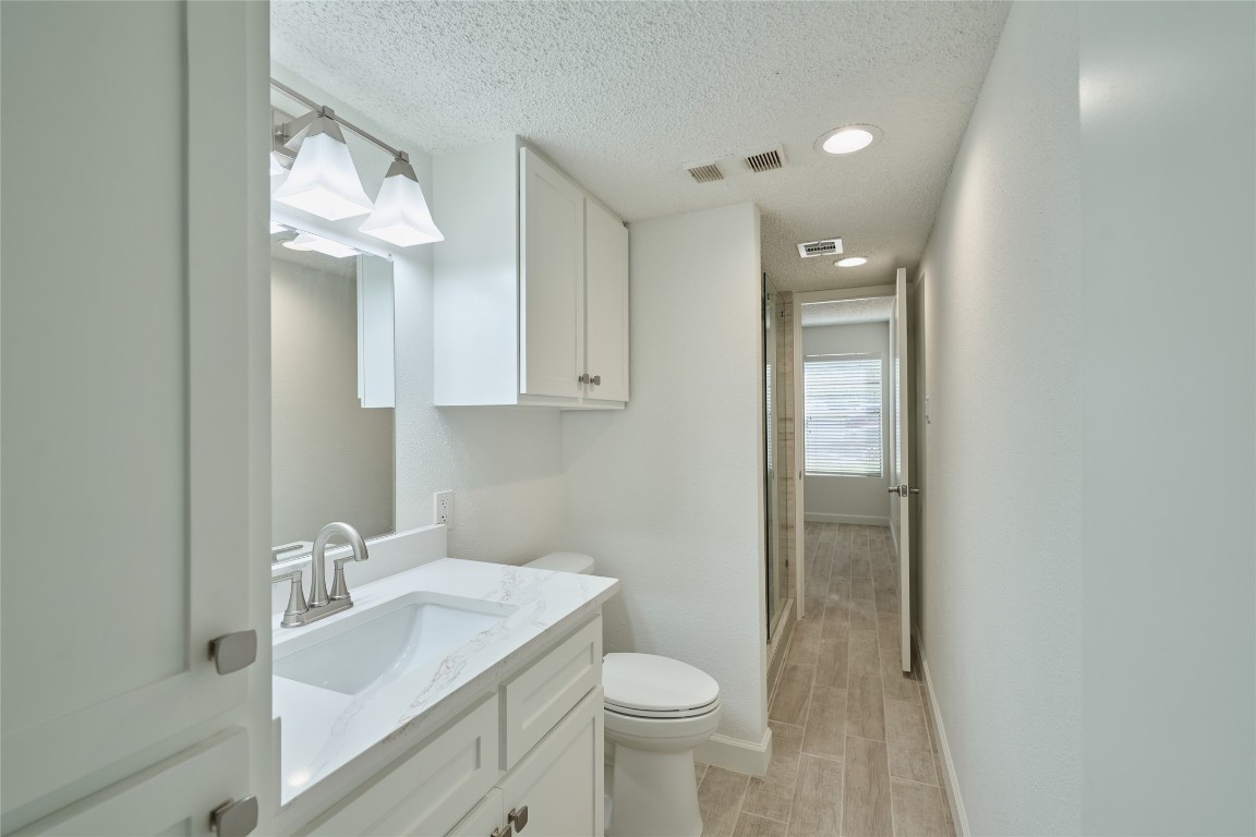 12900 Walden Road, Unit 601F Montgomery, TX 77356 - Photo 22 of 28 a bathroom with a sink a toilet and shower