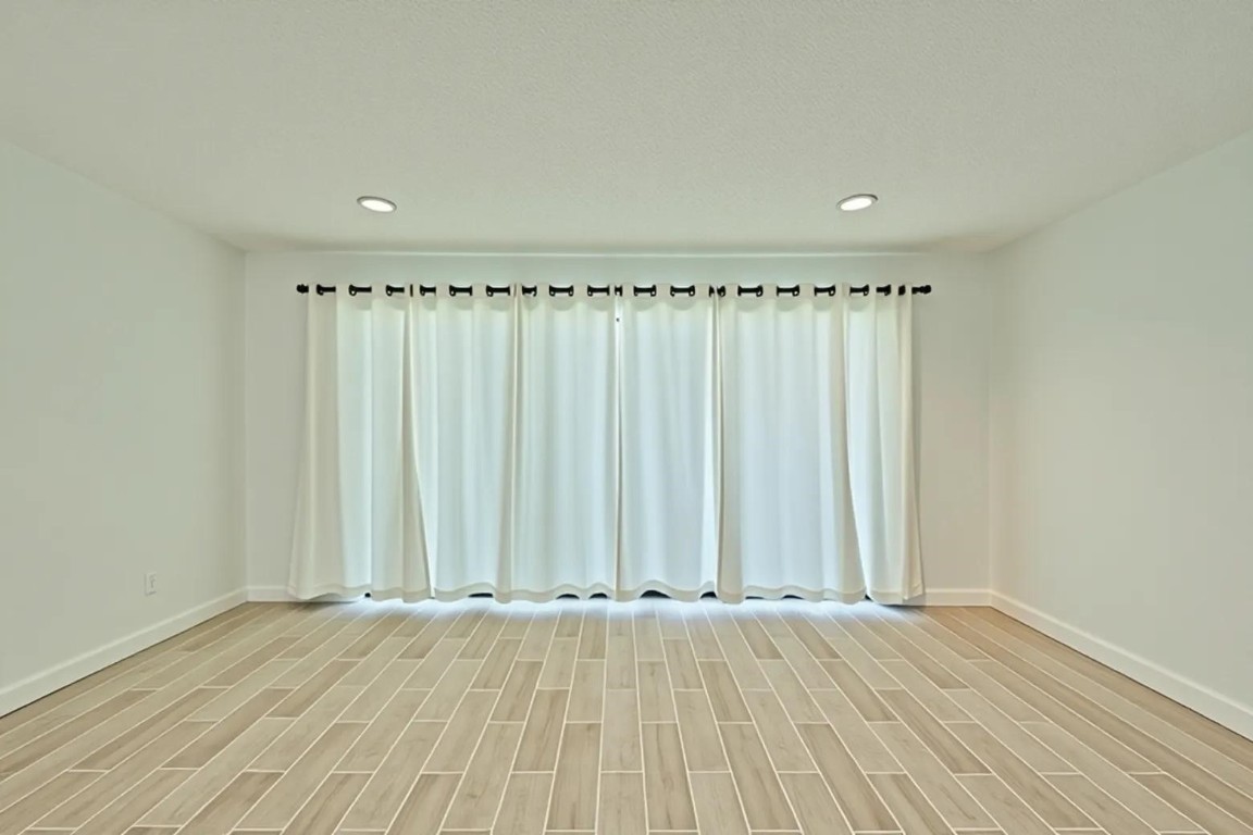 12900 Walden Road, Unit 601F Montgomery, TX 77356 - Photo 3 of 28 an empty room with wooden floor and sliding window