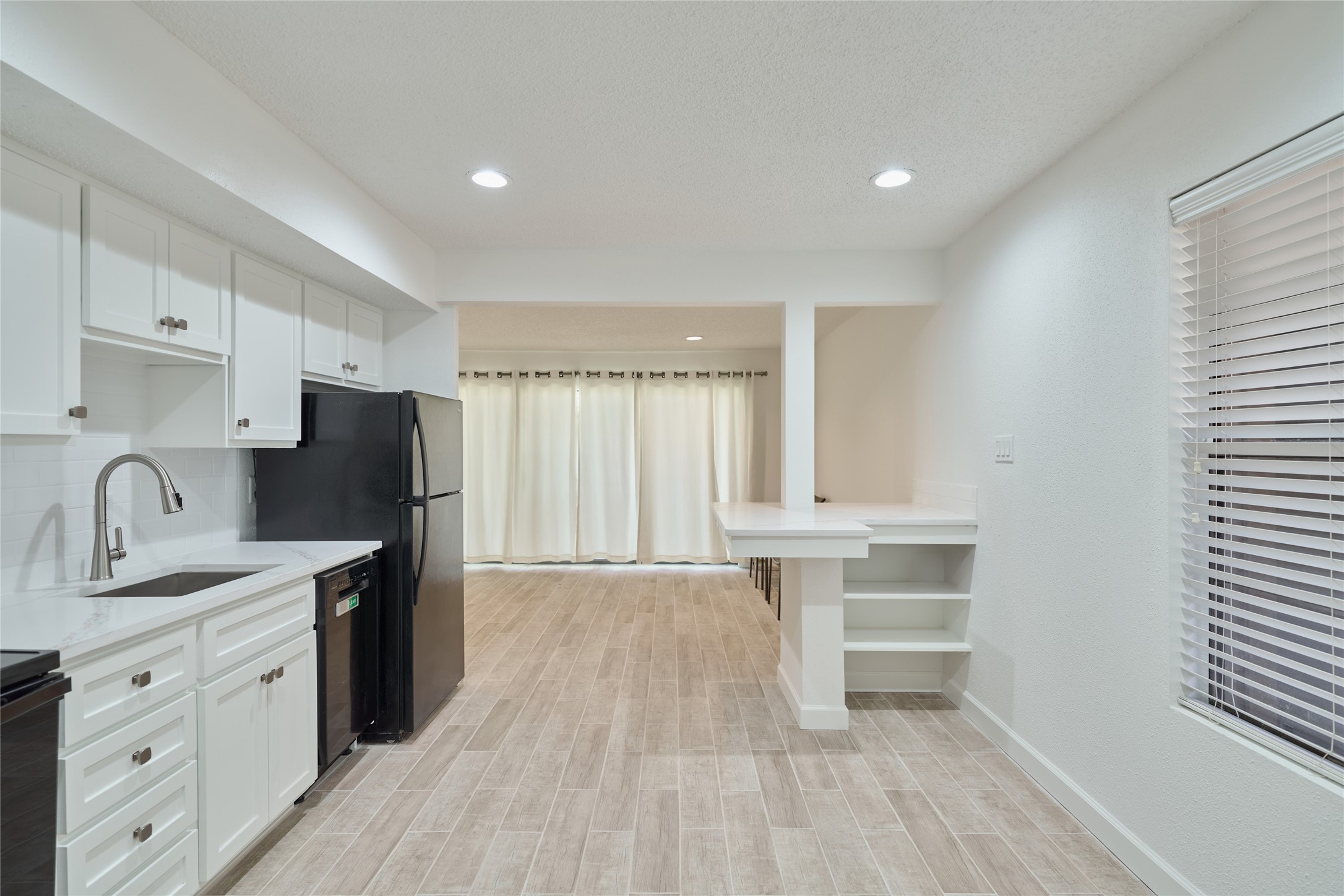 12900 Walden Road, Unit 601F Montgomery, TX 77356 - Photo 8 of 28 Feel right at home in this beautiful condo. All new wood look tile floors, quartz counters & breakfast bar area
