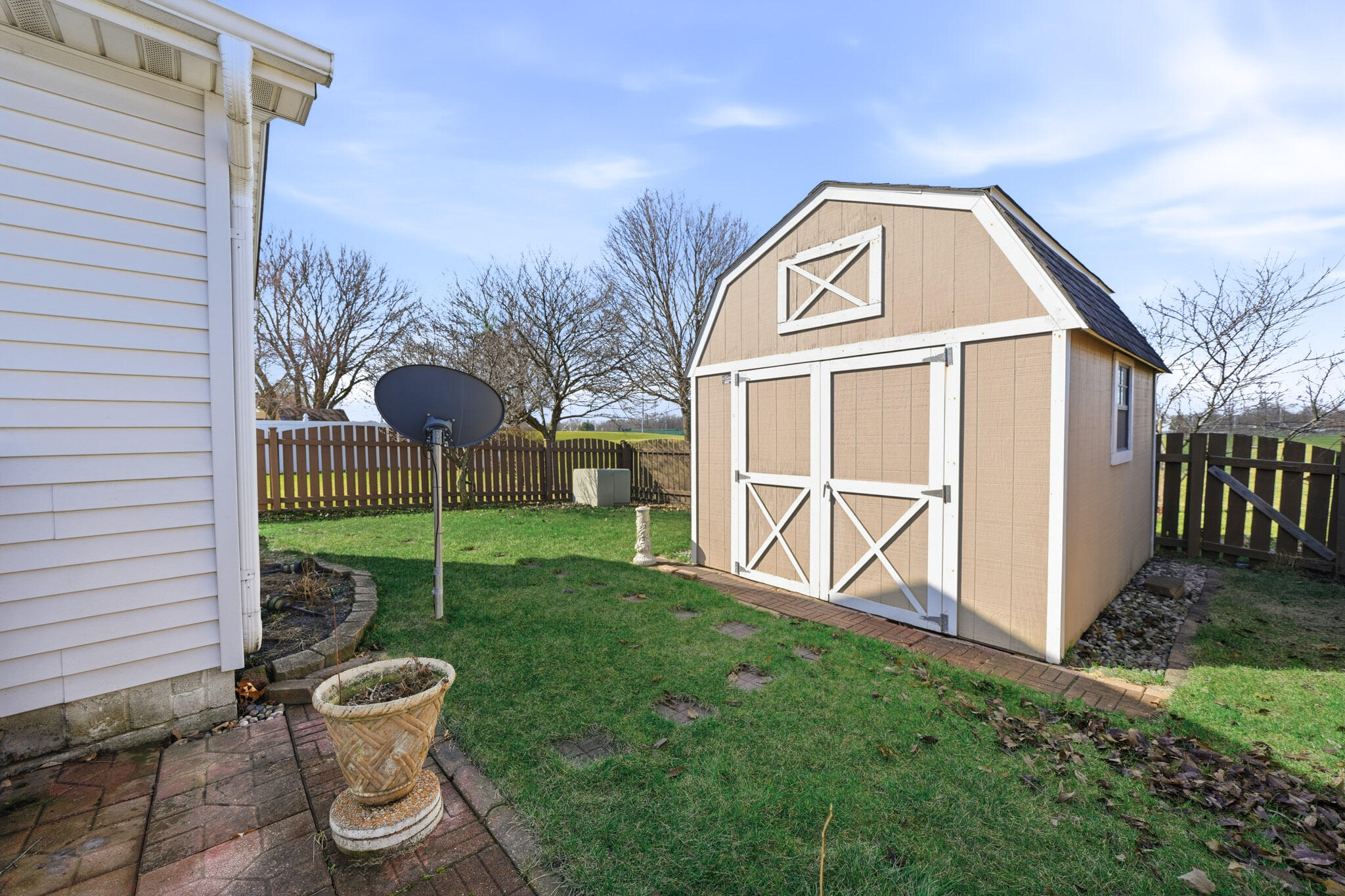 285 North Heather Lane Crown Point, IN 46307 - Photo 16 of 17 a view of a small house with a yard and wooden fence
