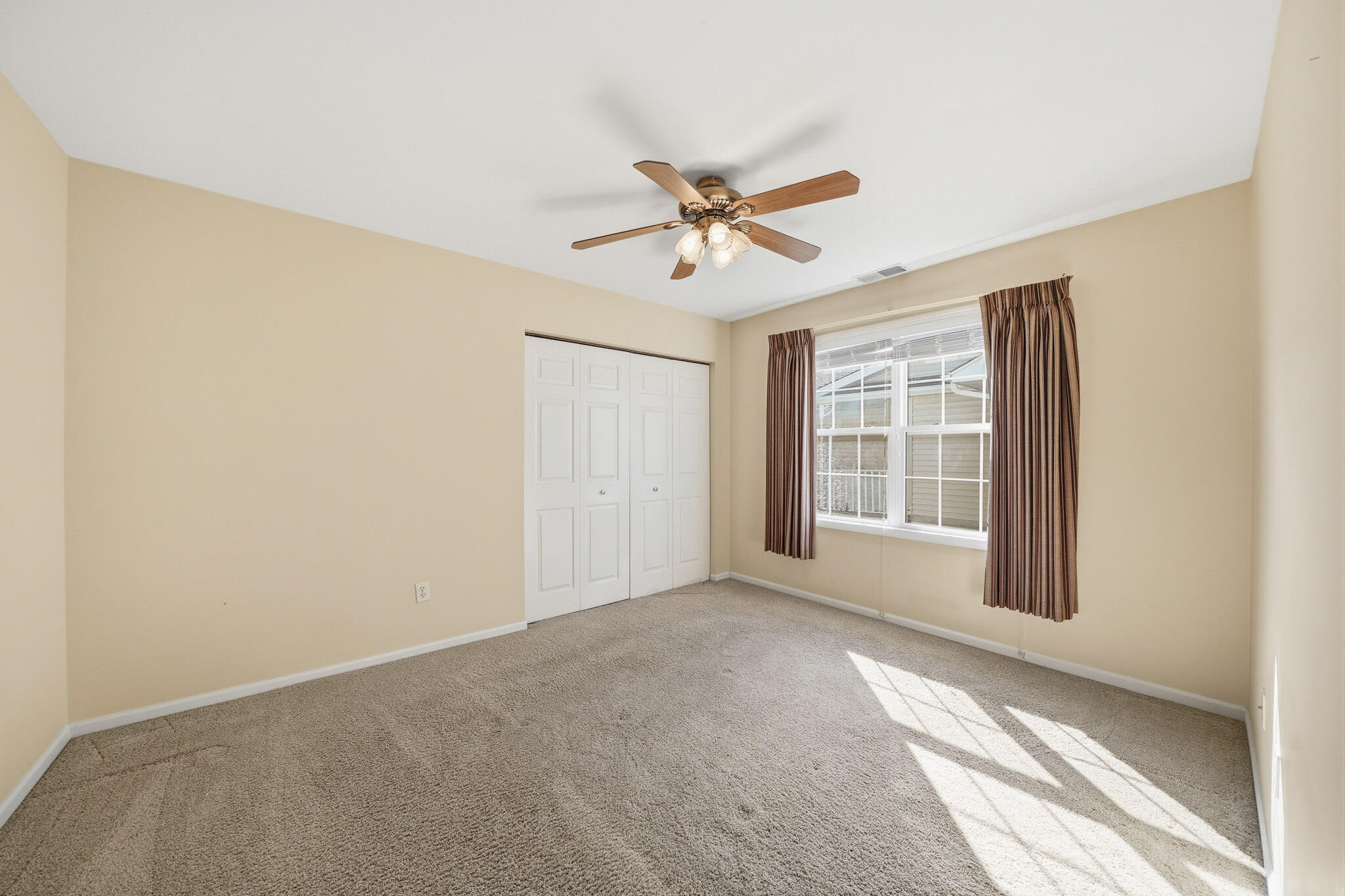 285 North Heather Lane Crown Point, IN 46307 - Photo 8 of 17 a view of a livingroom with a ceiling fan and window