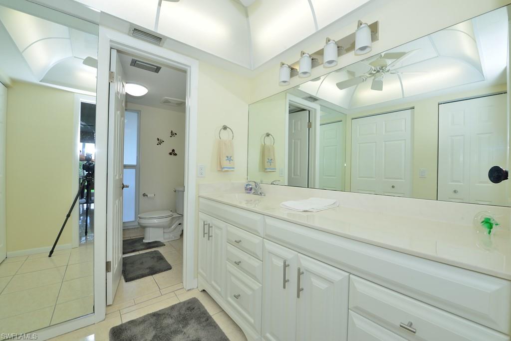 124 Penny Lane, Unit 778 Naples, FL 34112 - Photo 11 of 13 a spacious bathroom with a shower sink and mirror