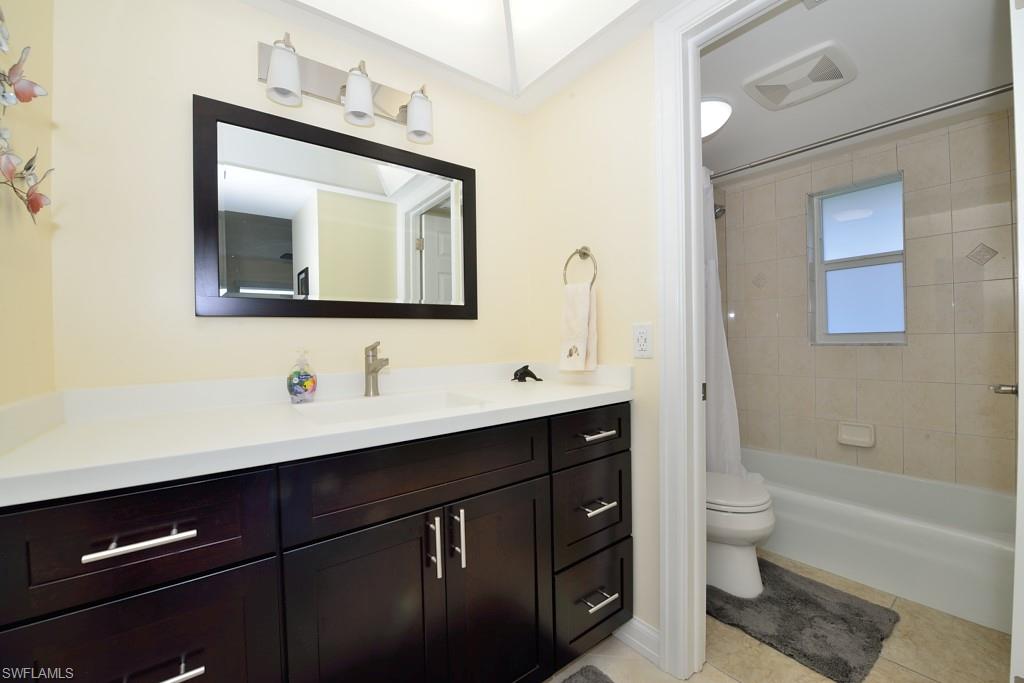 124 Penny Lane, Unit 778 Naples, FL 34112 - Photo 13 of 13 a bathroom with a toilet sink double vanity and bathtub