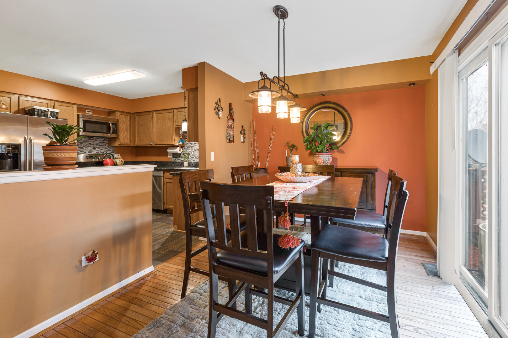 1467 Exeter Lane South Elgin, IL 60177 - Photo 6 of 29 a dining room with furniture a chandelier and wooden floor