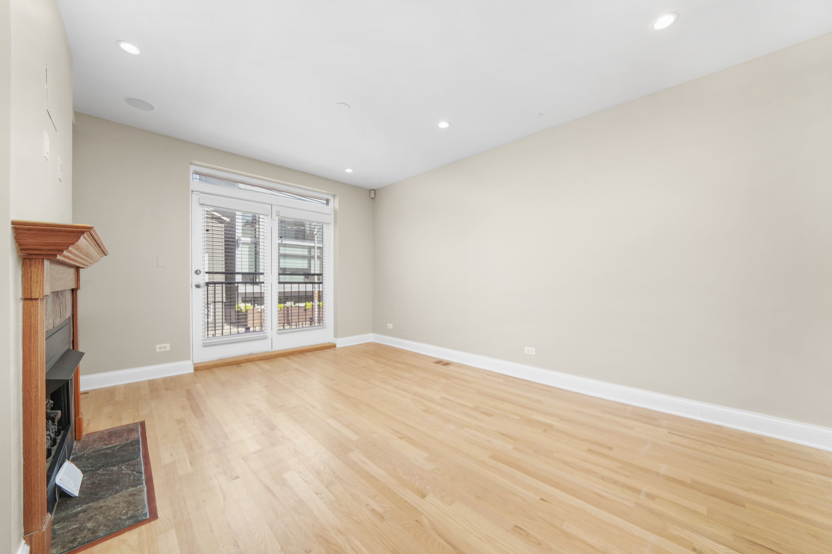 1640 West Ohio Street, Unit 1R Chicago, IL 60622 - Photo 6 of 13 an empty room with wooden floor and windows