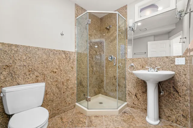 a bathroom with a sink toilet and shower