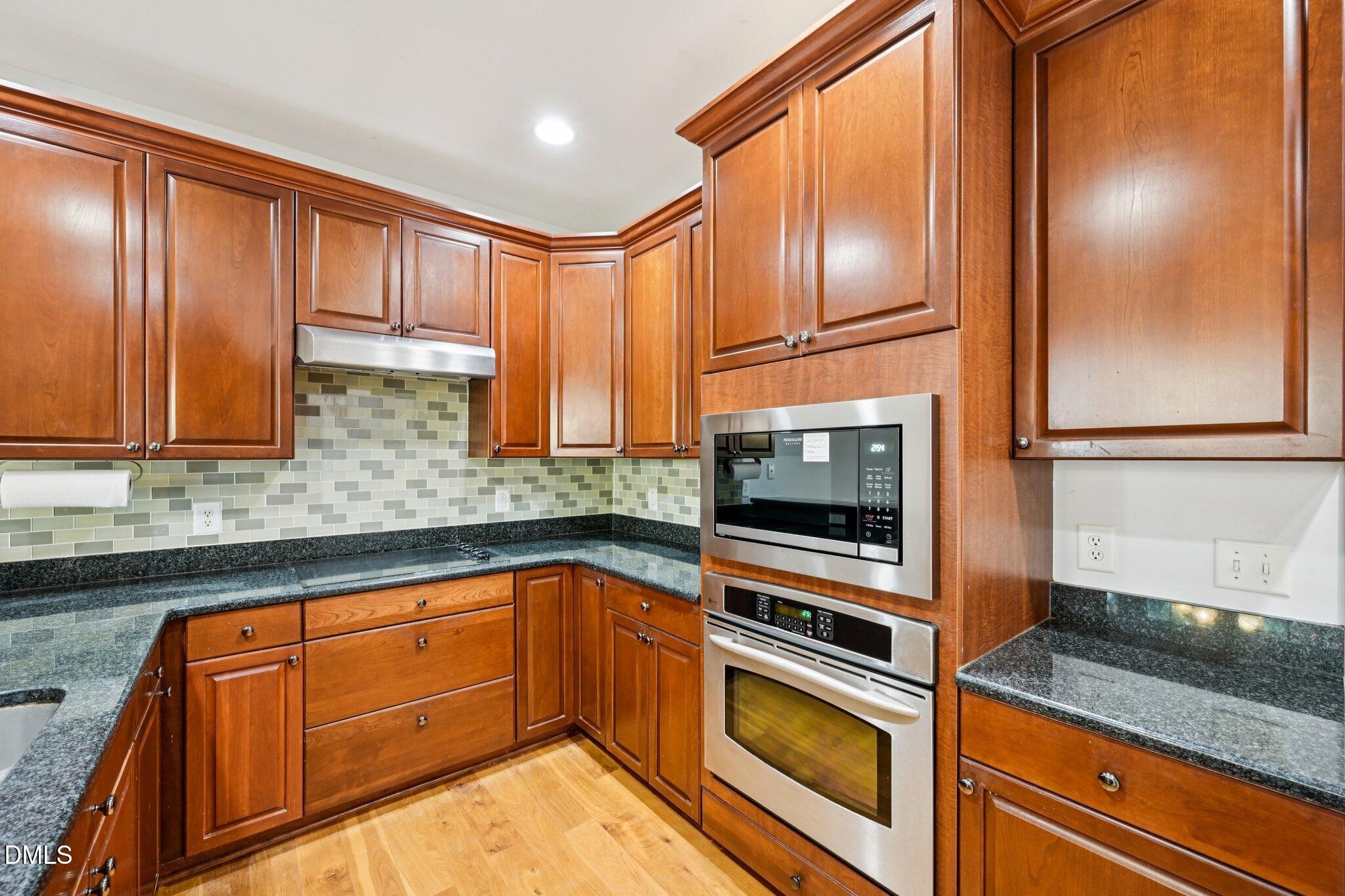 7628 Stony Hill Road Wake Forest, NC 27587 - Photo 11 of 33 a kitchen with granite countertop stainless steel appliances and cabinets