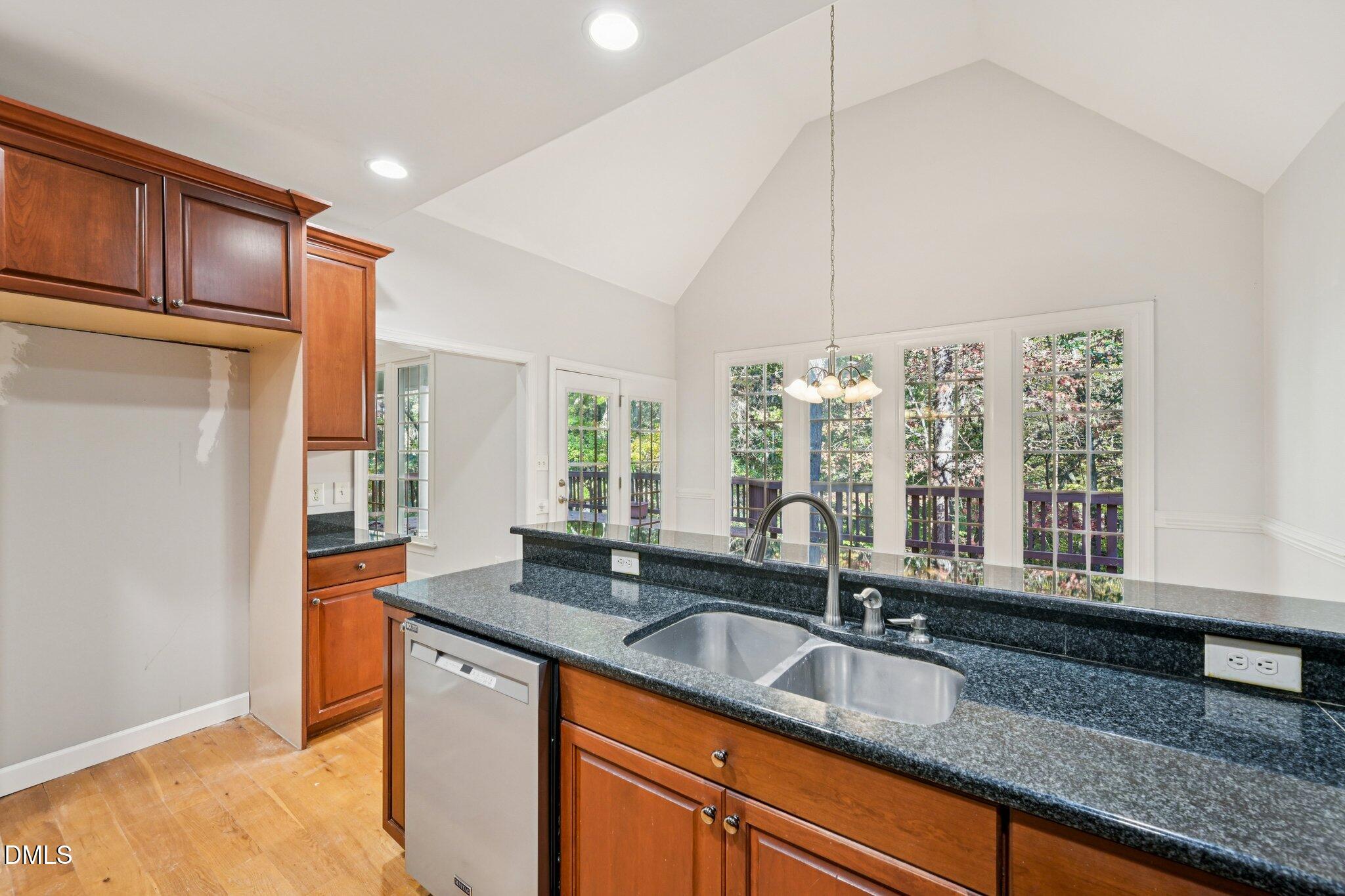 7628 Stony Hill Road Wake Forest, NC 27587 - Photo 13 of 33 a kitchen with granite countertop a sink and a window