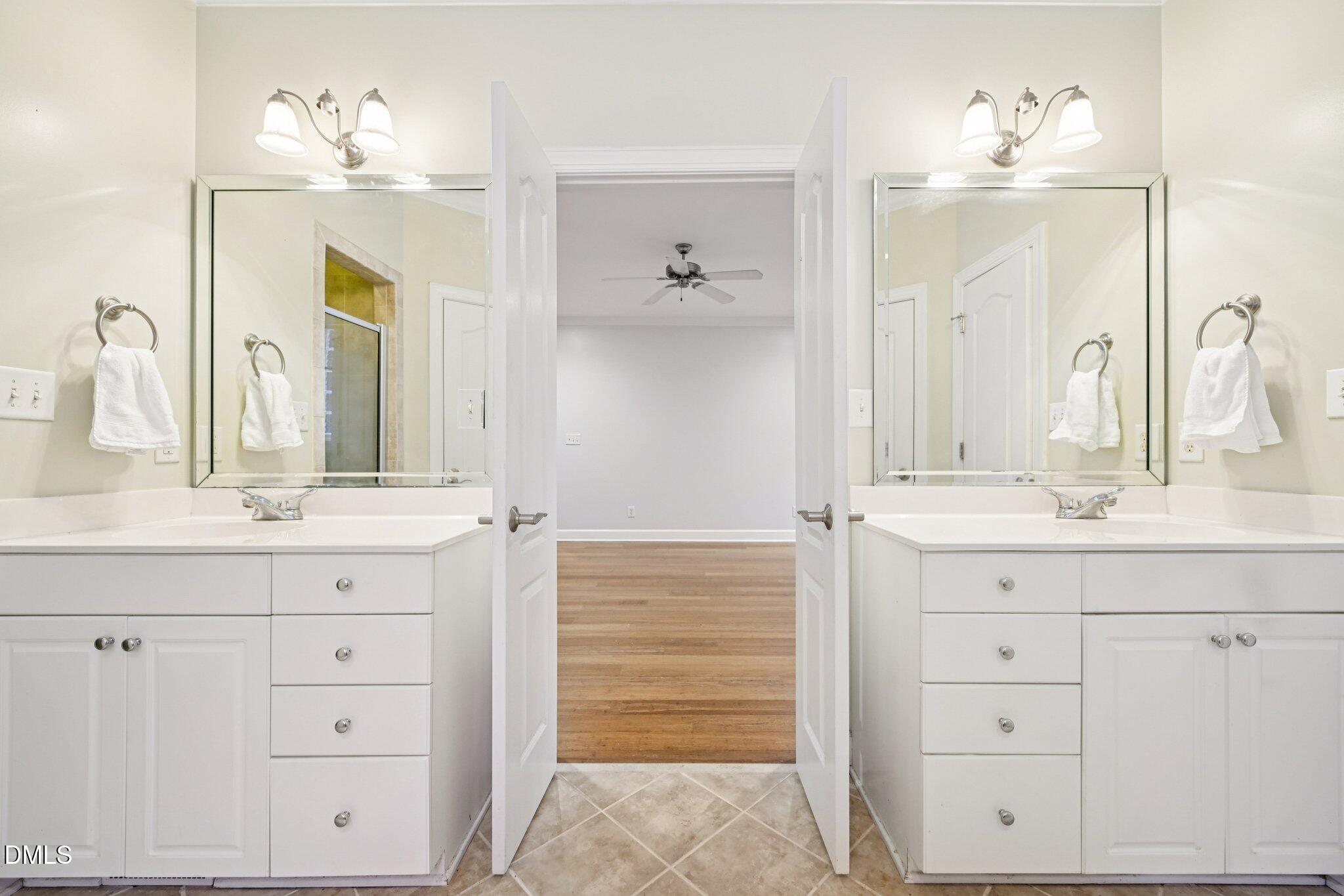 7628 Stony Hill Road Wake Forest, NC 27587 - Photo 23 of 33 a bathroom with double vanity sink and a mirror