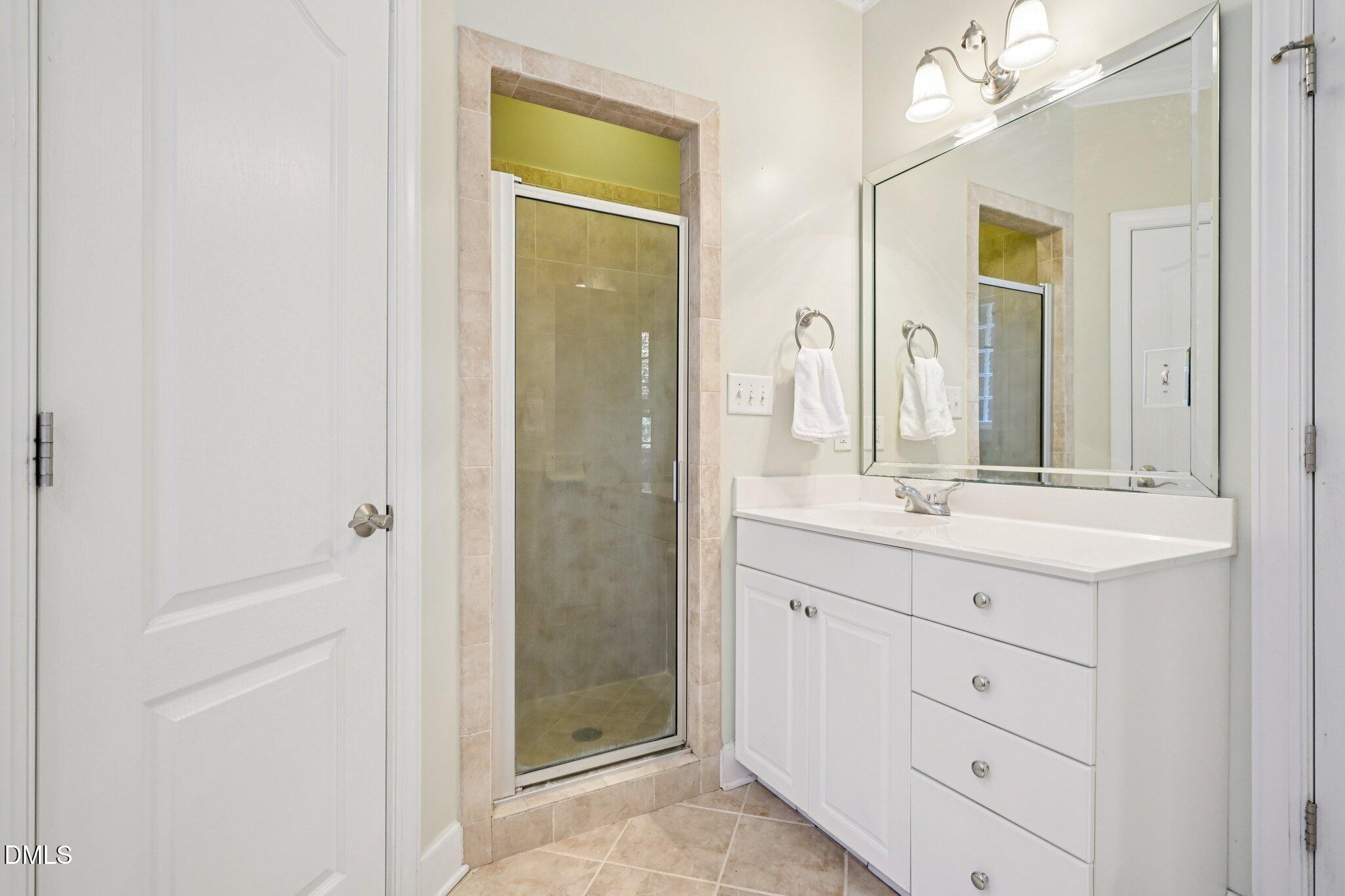 7628 Stony Hill Road Wake Forest, NC 27587 - Photo 24 of 33 a bathroom with a double vanity sink and mirror