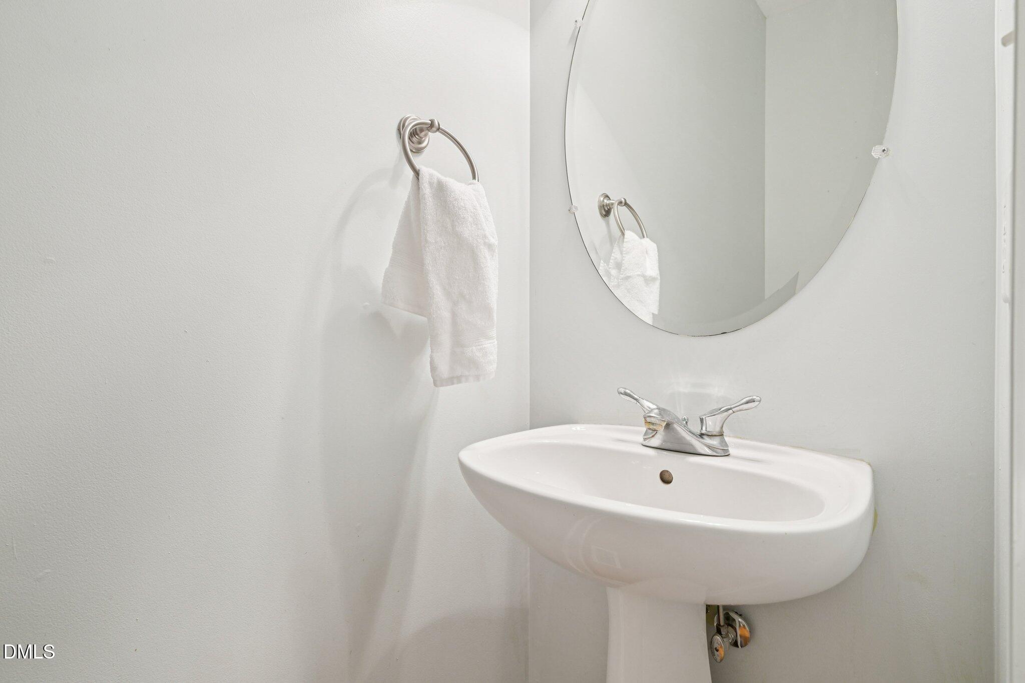 7628 Stony Hill Road Wake Forest, NC 27587 - Photo 27 of 33 a bathroom with a sink a mirror and a shower