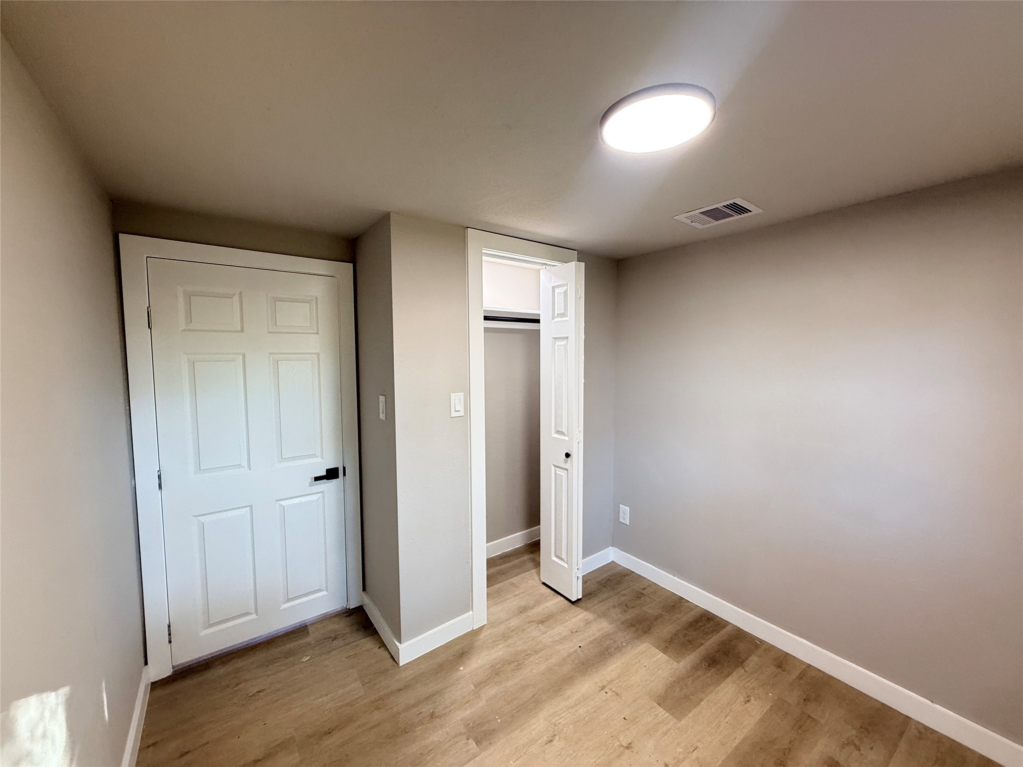 2209 Gano Street, Unit 3 Houston, TX 77009 - Photo 12 of 16 an empty room with wooden floor and windows