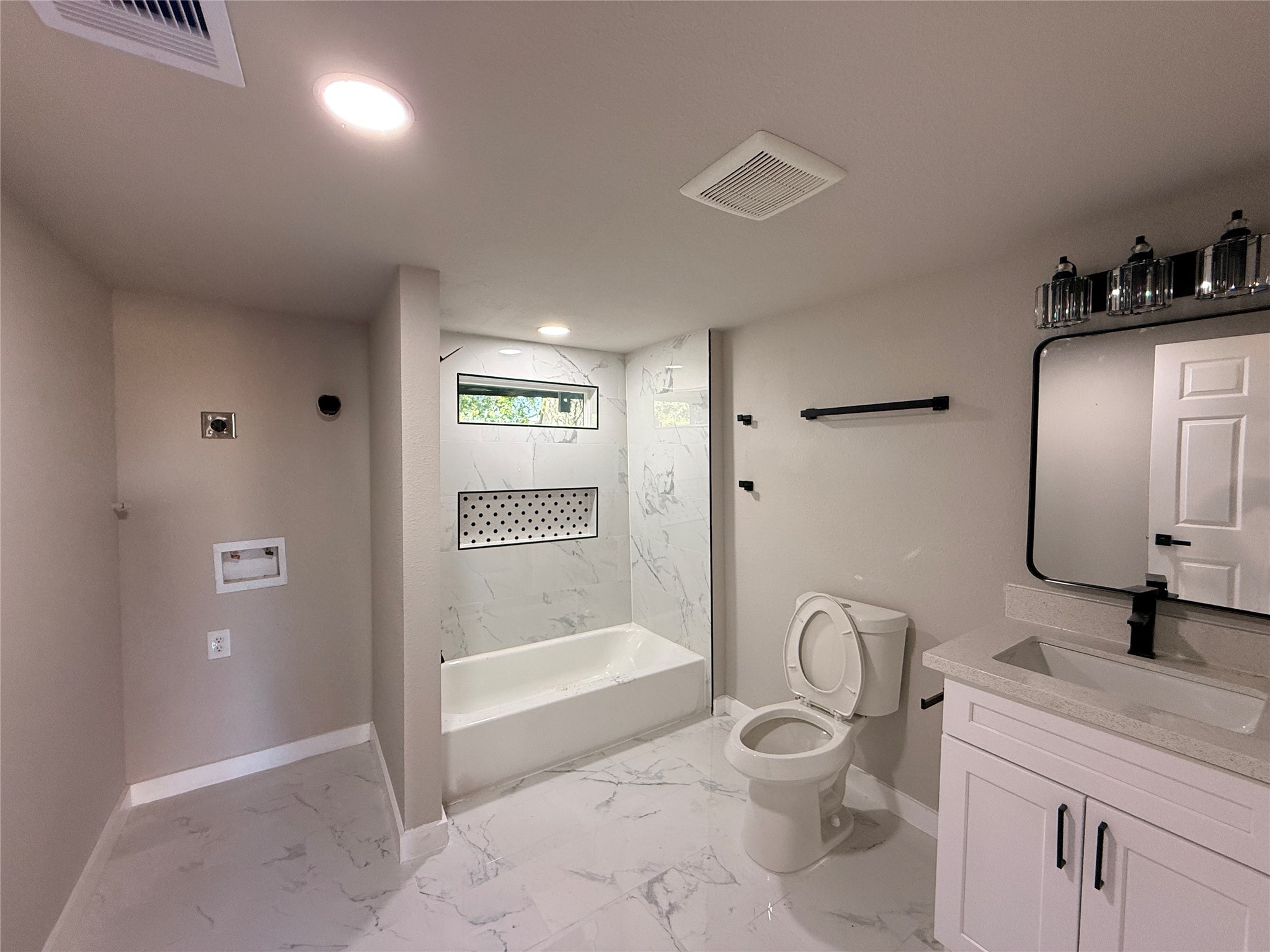 2209 Gano Street, Unit 3 Houston, TX 77009 - Photo 3 of 16 a bathroom with a granite countertop sink a toilet a mirror and shower