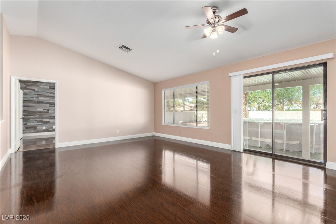6465 West Plumcrest Road Las Vegas, NV 89108 - Photo 16 of 34 Empty room with lofted ceiling, dark wood-type flooring, and ceiling fan