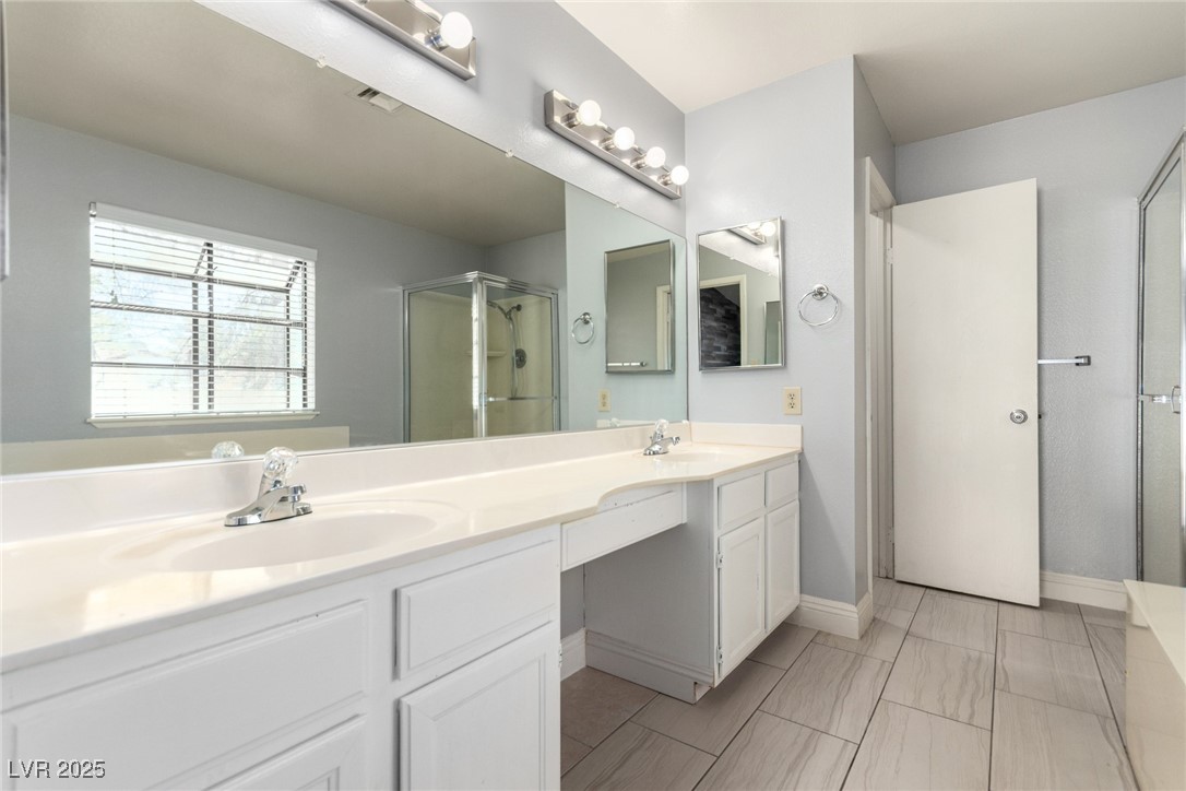 6465 West Plumcrest Road Las Vegas, NV 89108 - Photo 20 of 34 Bathroom featuring double vanity and a shower stall