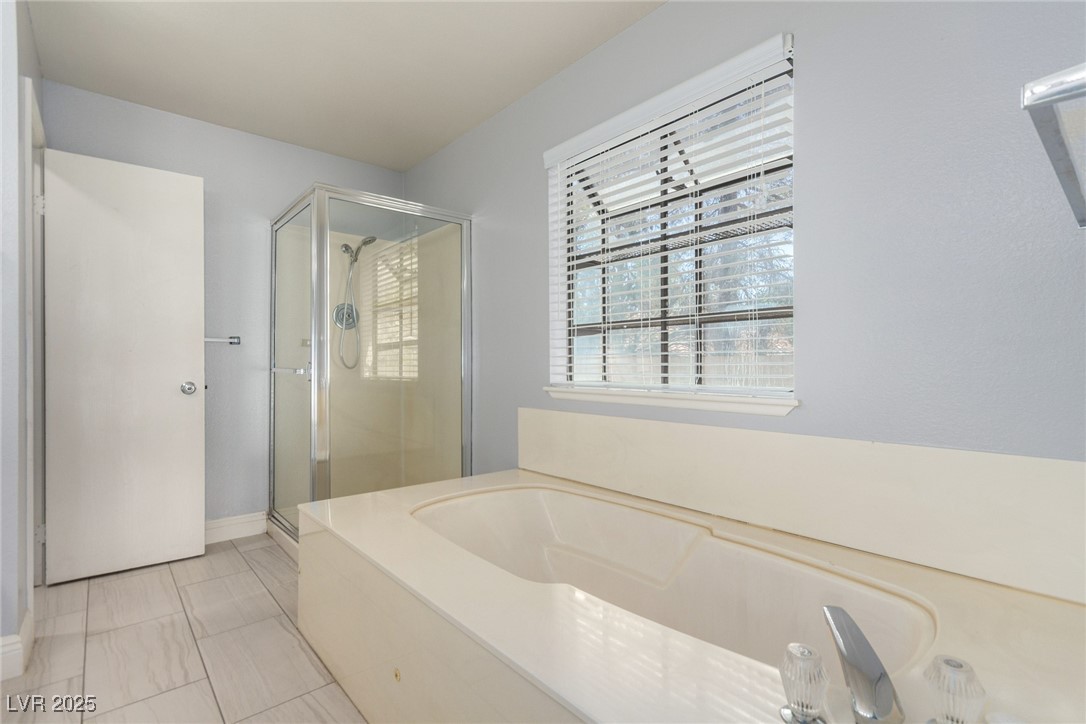 6465 West Plumcrest Road Las Vegas, NV 89108 - Photo 21 of 34 Full bath with a shower stall, a bath, and light tile patterned floors